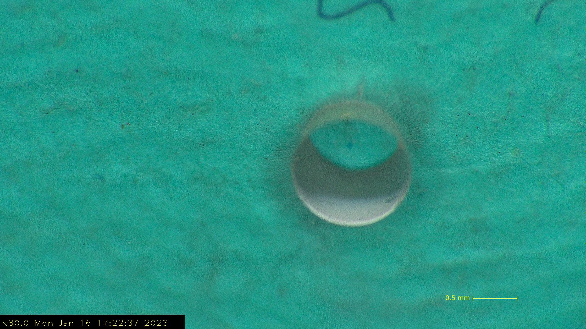 Laser-drilled glass — microscopy detail